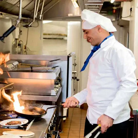 Heatherwood Chef Created Meals, chef frying a dish.