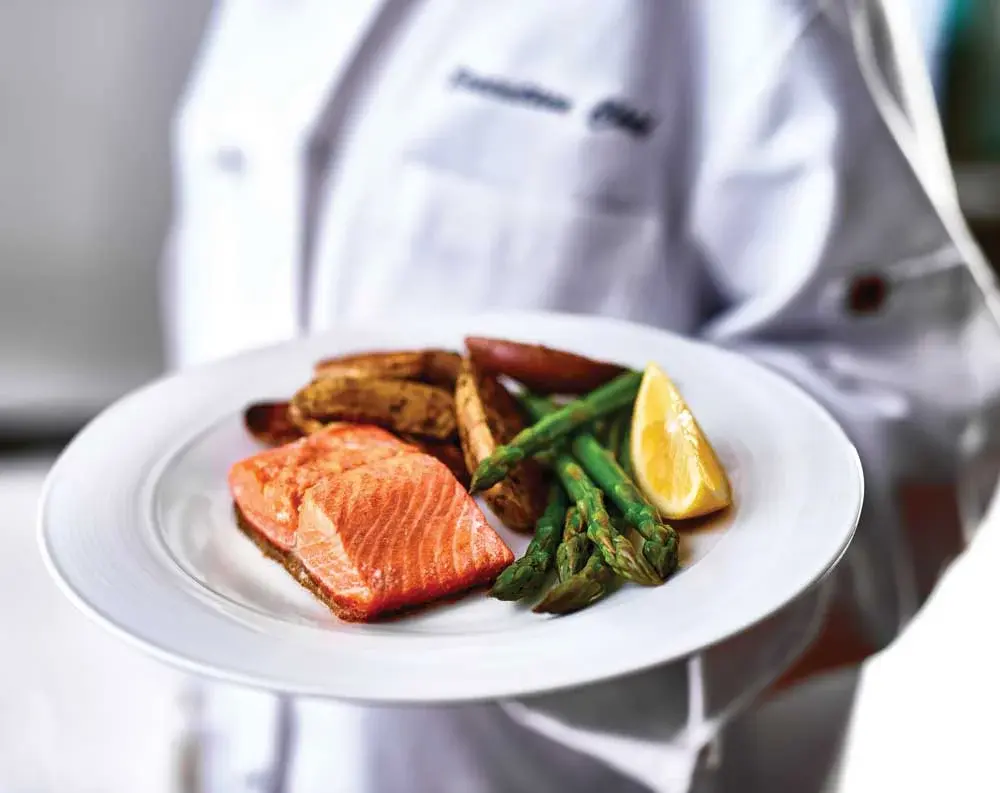 Heatherwood Chef Created Meals, chef delivering a finished dish.
